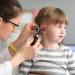 A Female Ent Doctor Examining a Child’s Ear With an Otoscope Ear Infections in Children